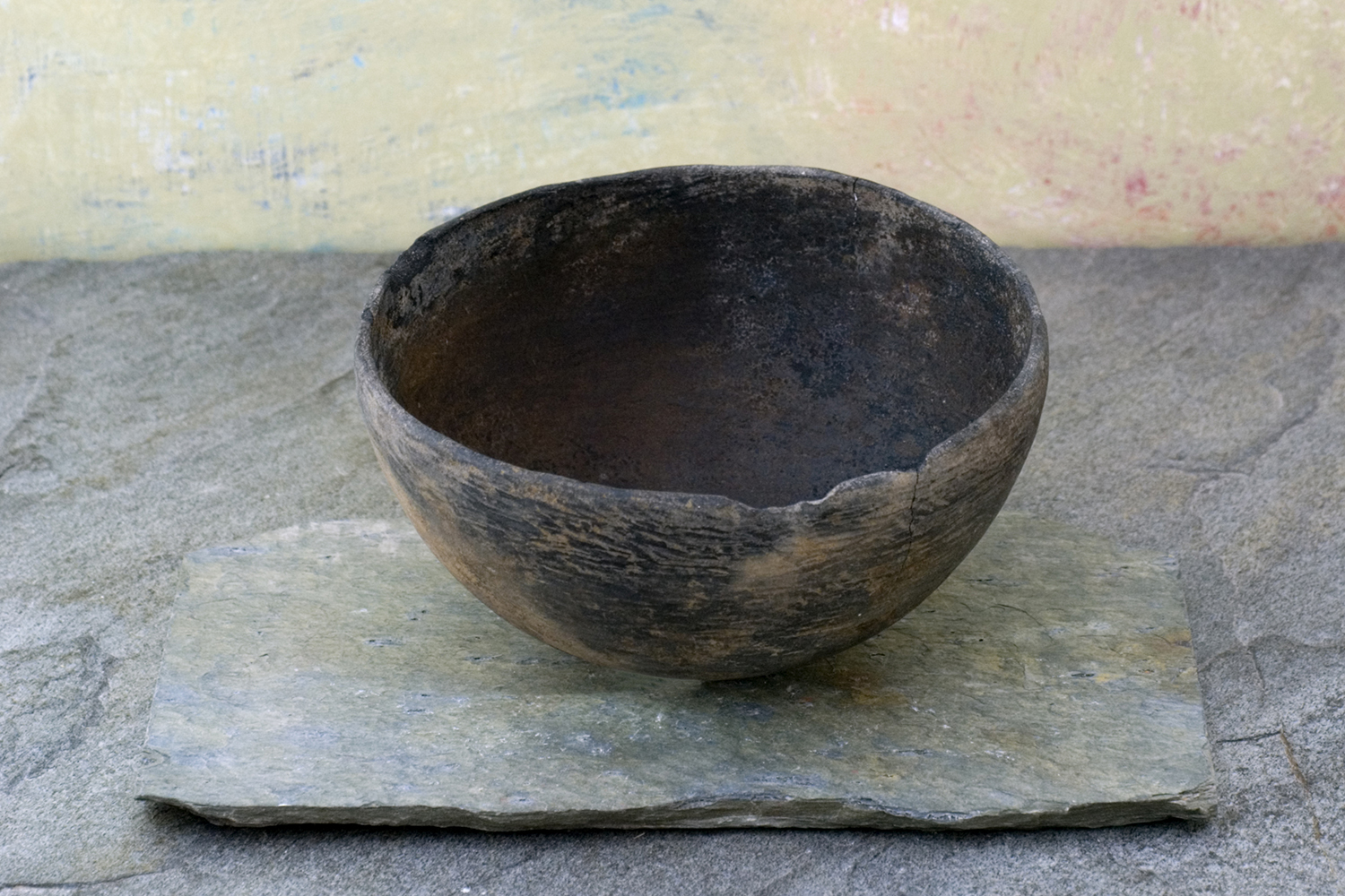 a misshapen bowl on a weathered slab