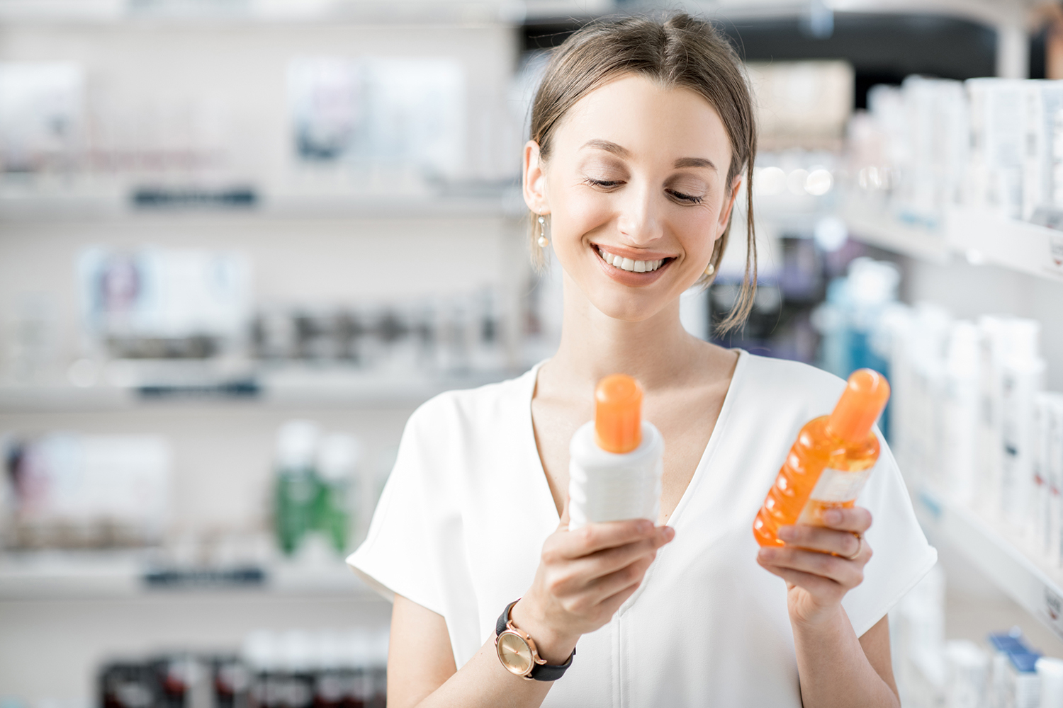 a woman comparing two containers of sunscreen