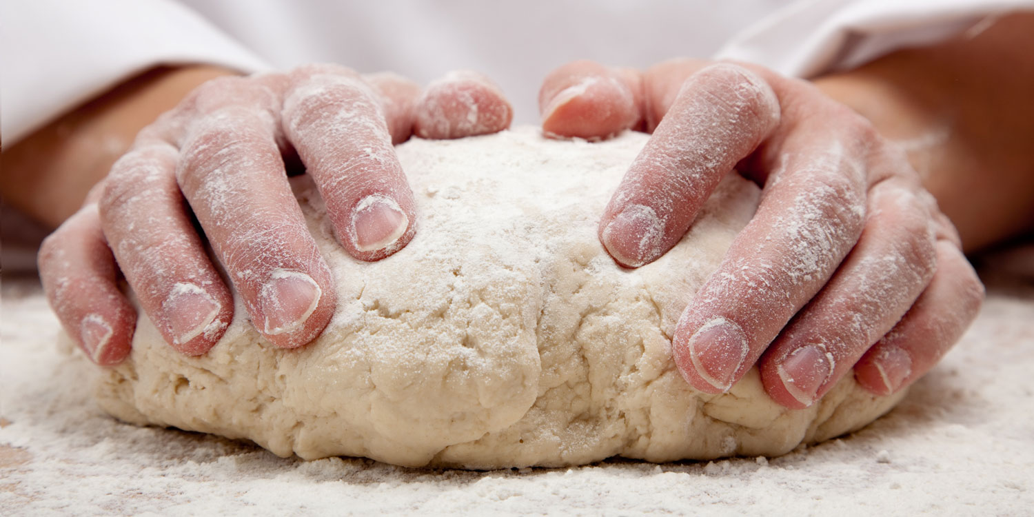 hands kneading bread