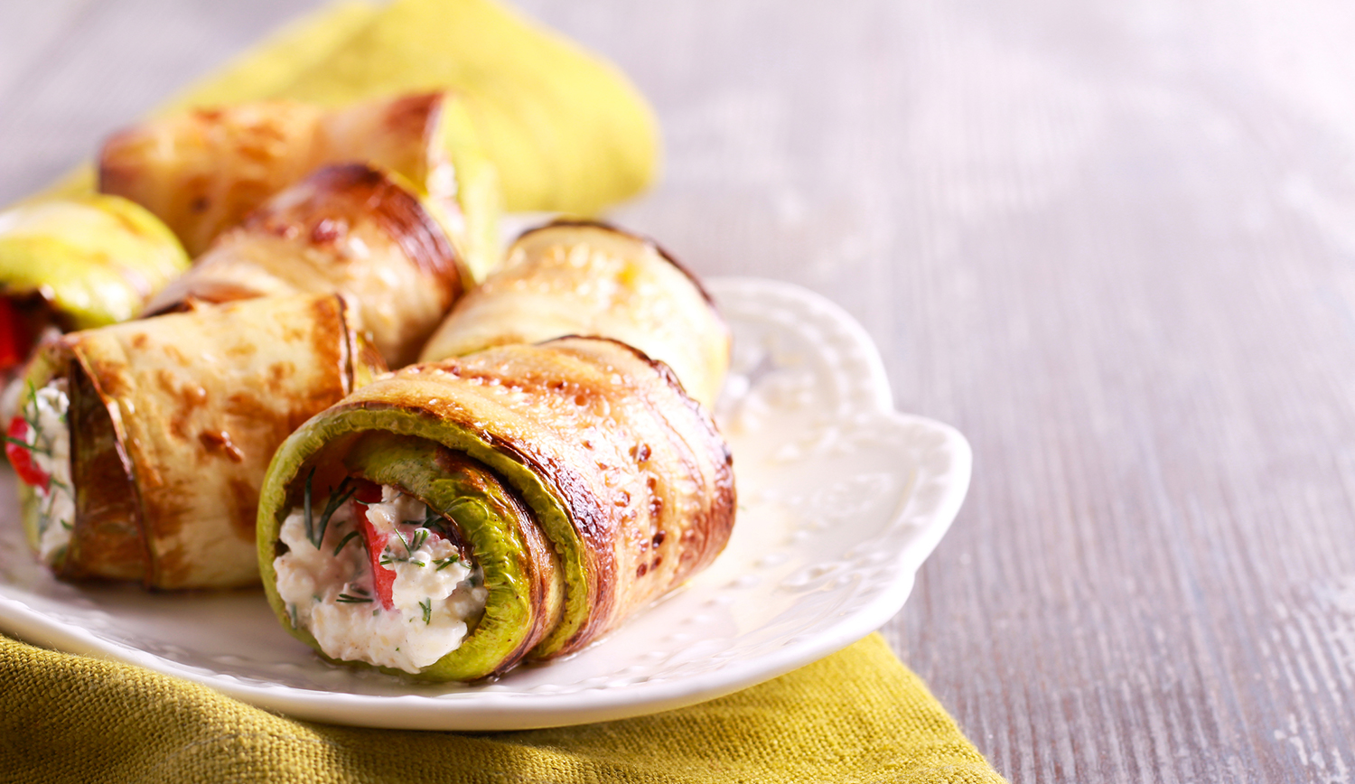 Zucchini Rolls on a white plate ready to enjoy.