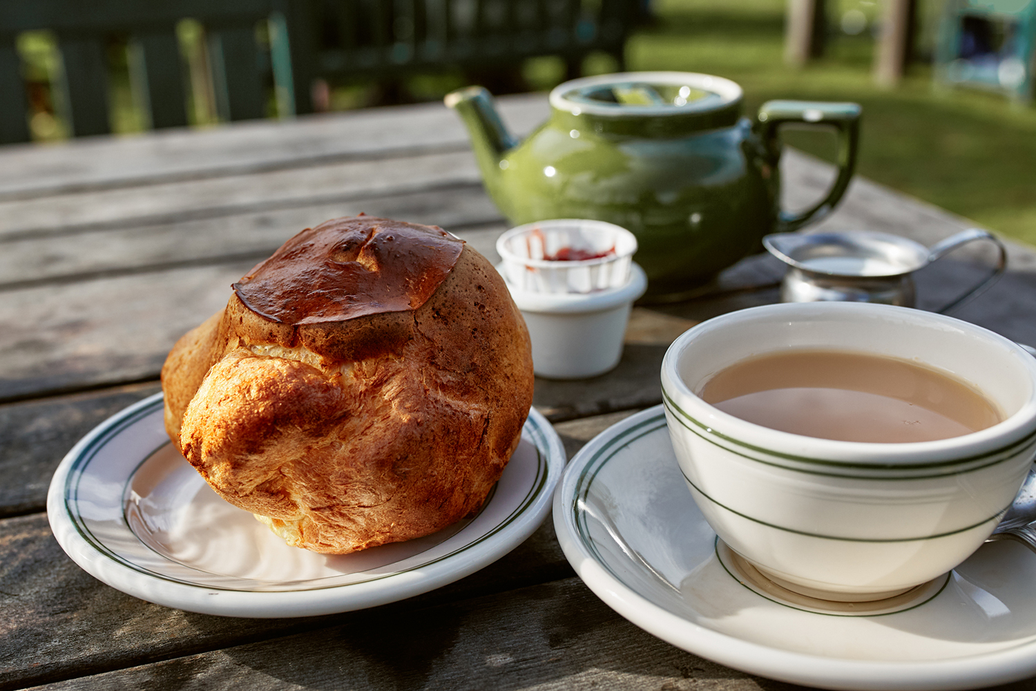 fresh-baked popovers served with berry jam and a pot of tea