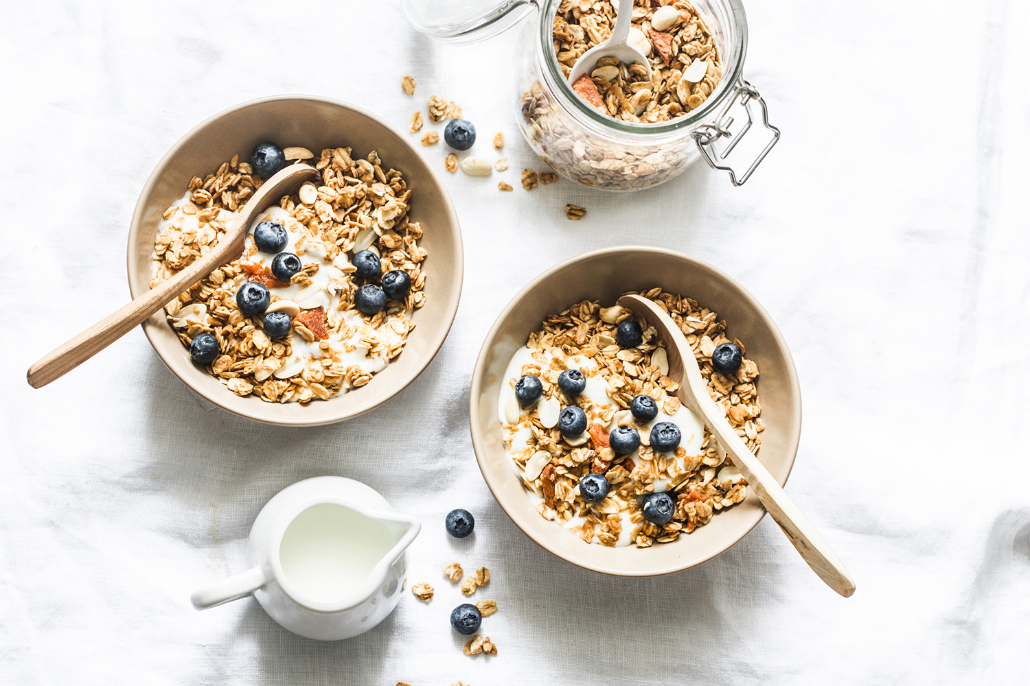 bowls of nuts, seeds, and blueberries