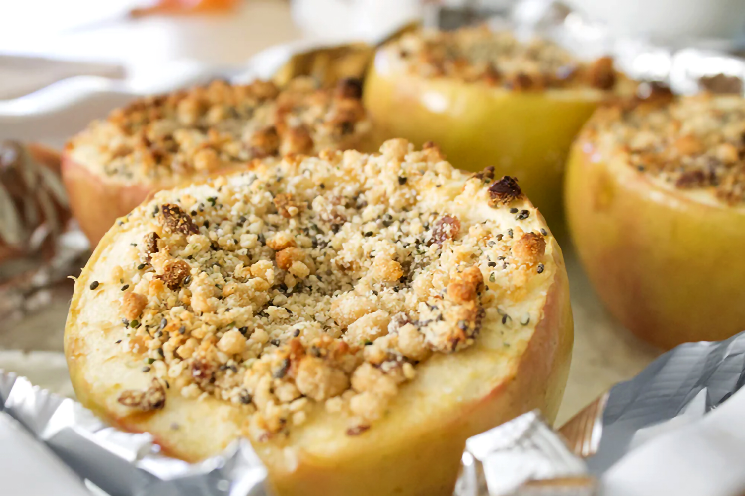 baked apples stuffing with filling and topped with crumble