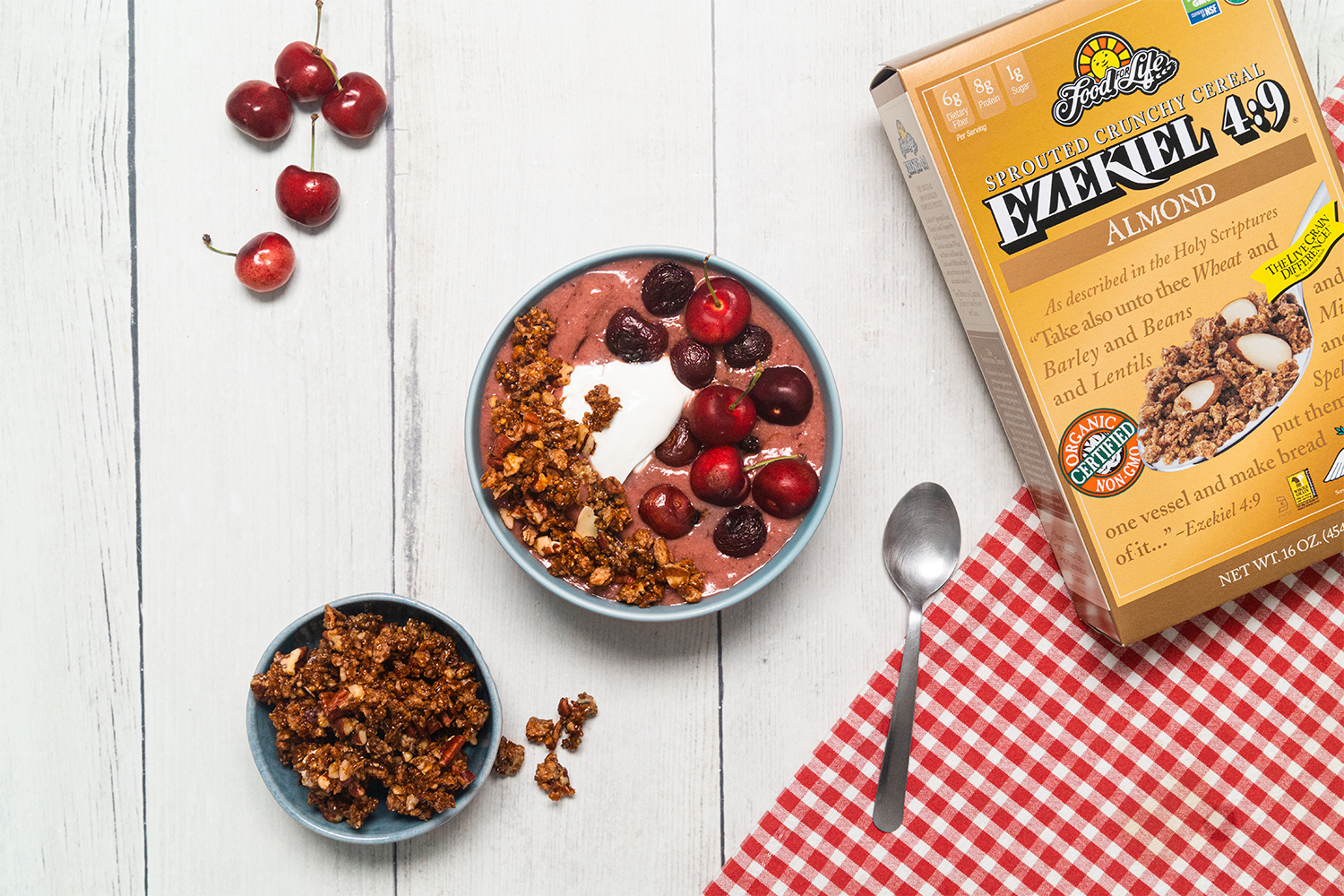 a bowl of cherry smoothie topped with almond crisp