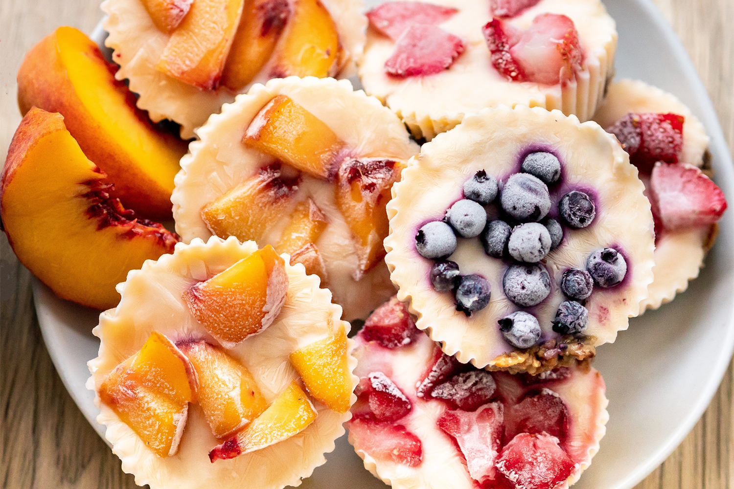 frozen yogurt in cupcake papers with fruit on top