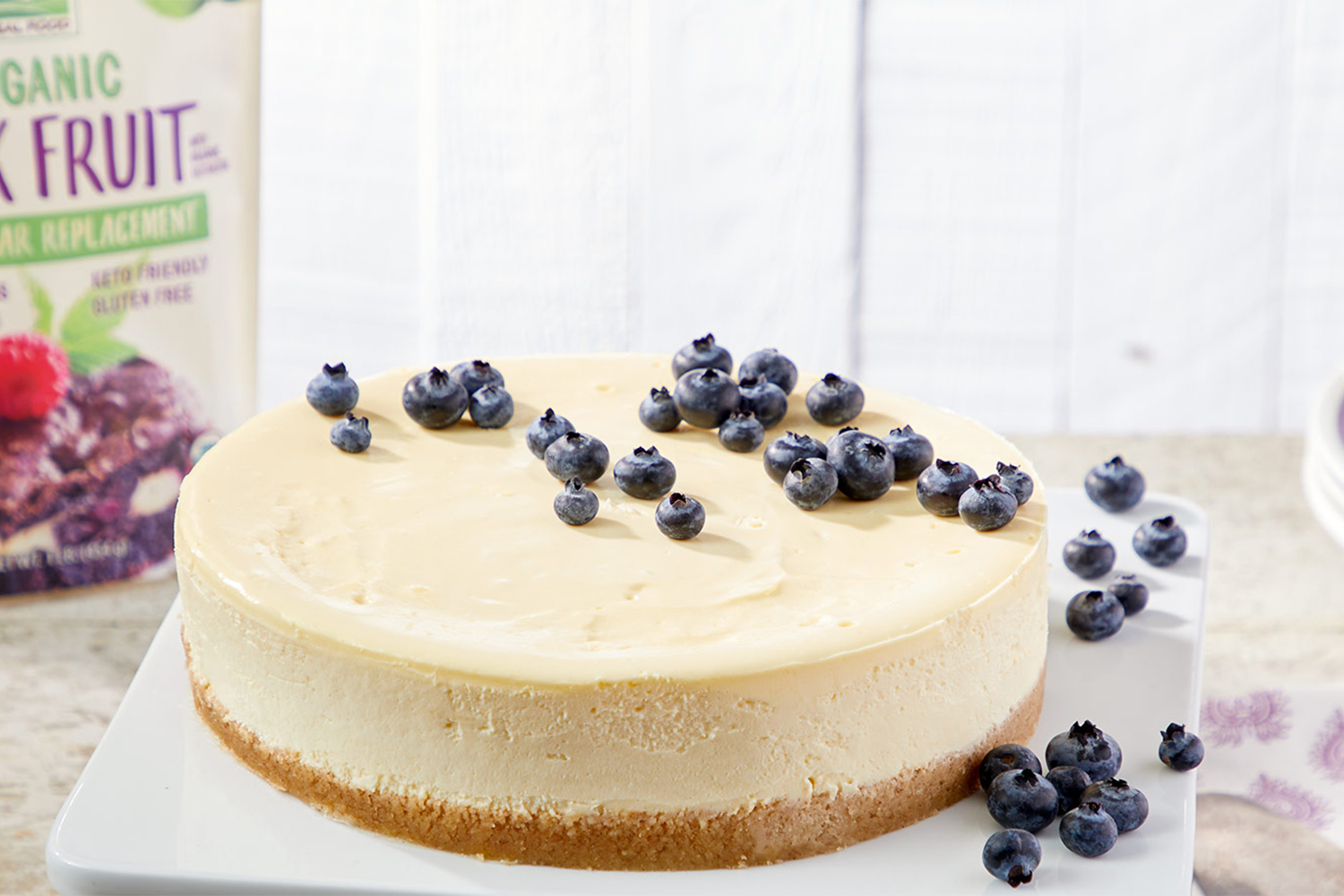 cheesecake on a graham crust with blueberries on top