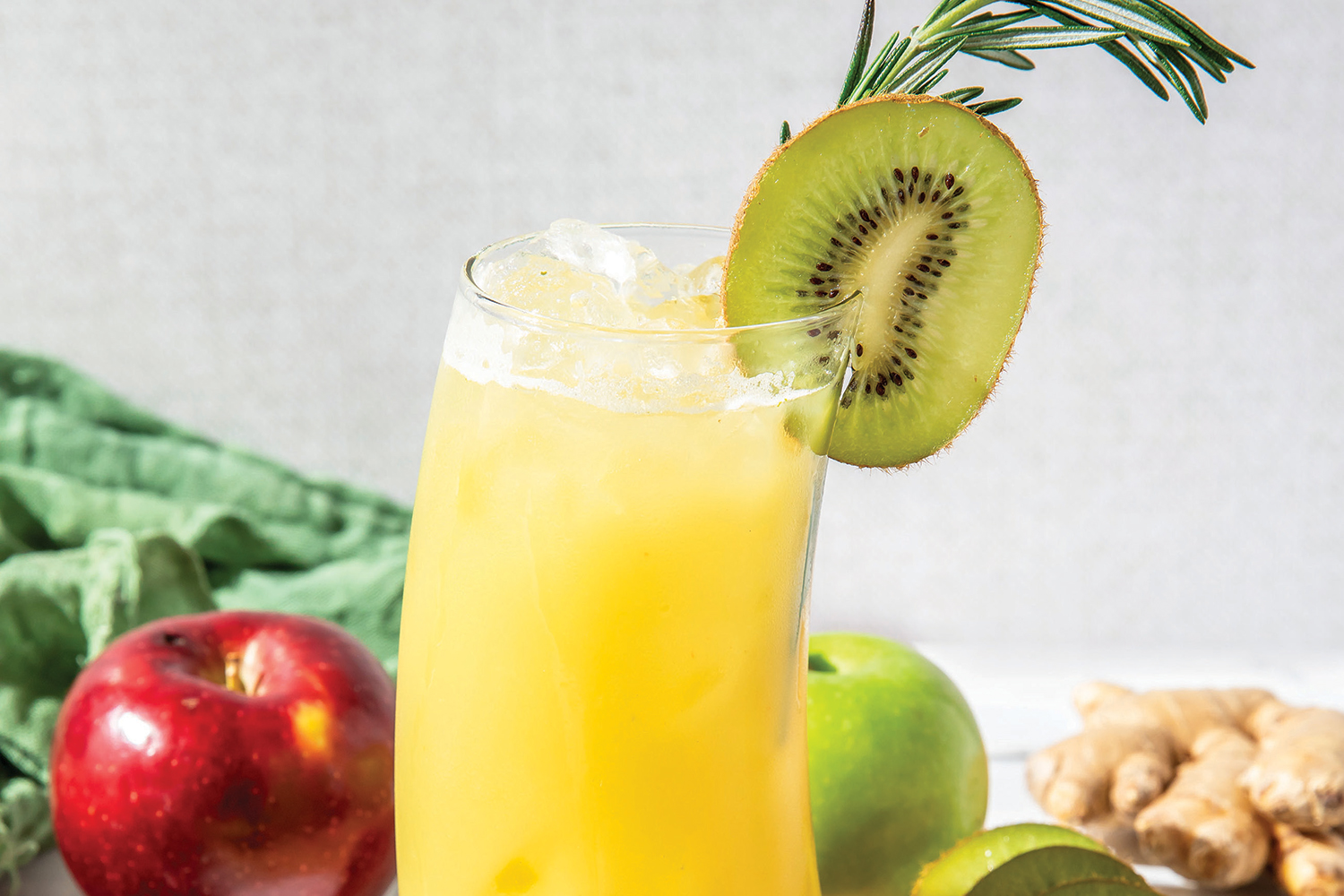 a smoothie with kiwis, apples, and rosemary