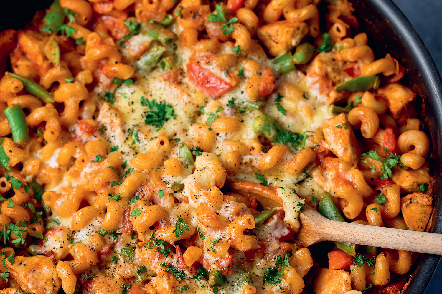 a skillet filled with pasta and chicken