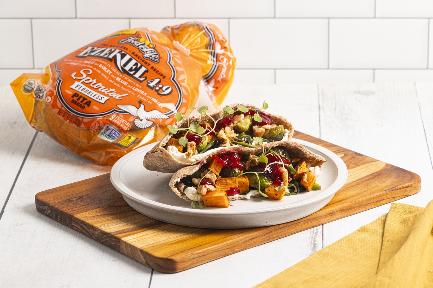 pita bread stuffed with cranberries and vegetables on cutting board
