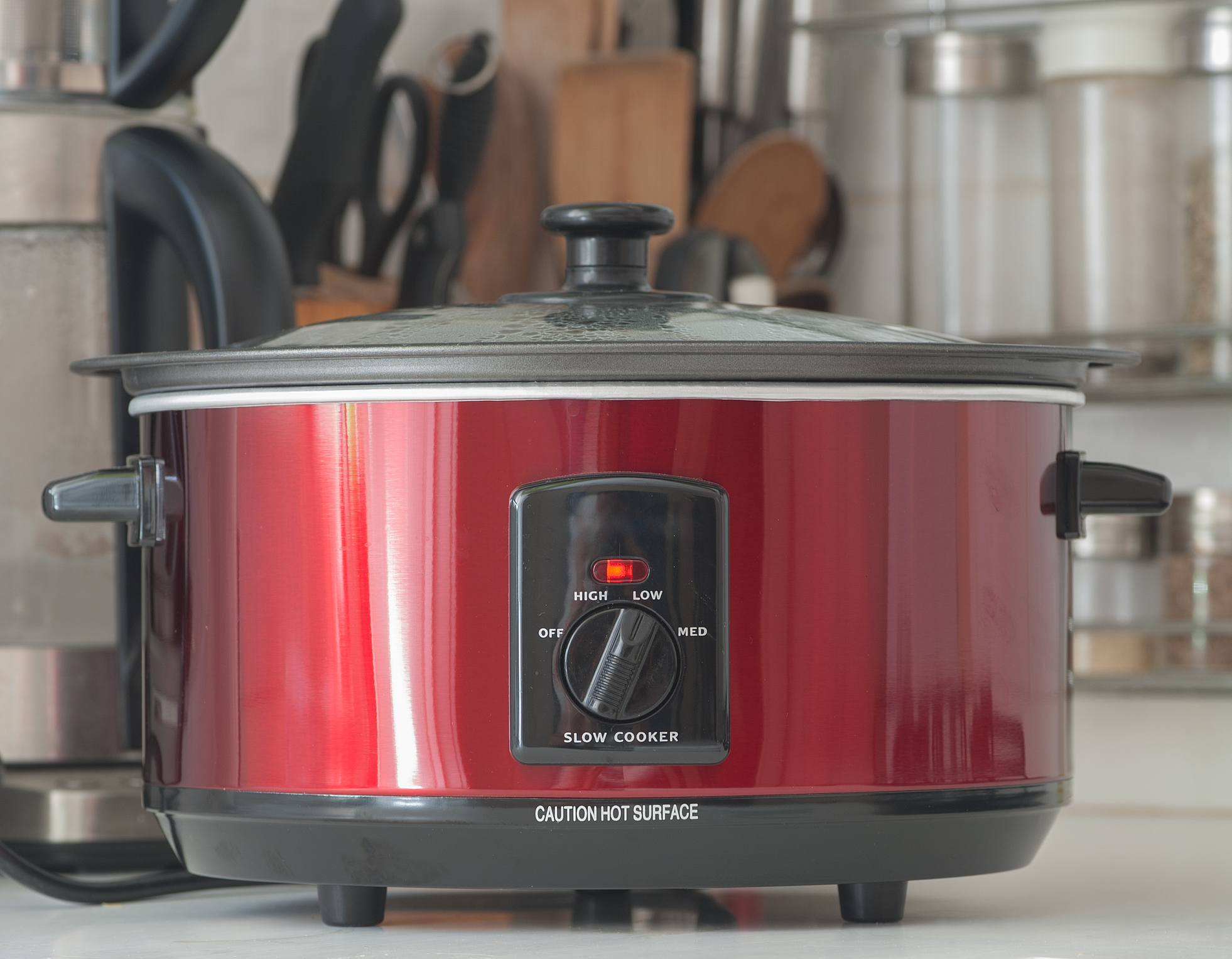 A slow cooker in use on a kitchen counter top.