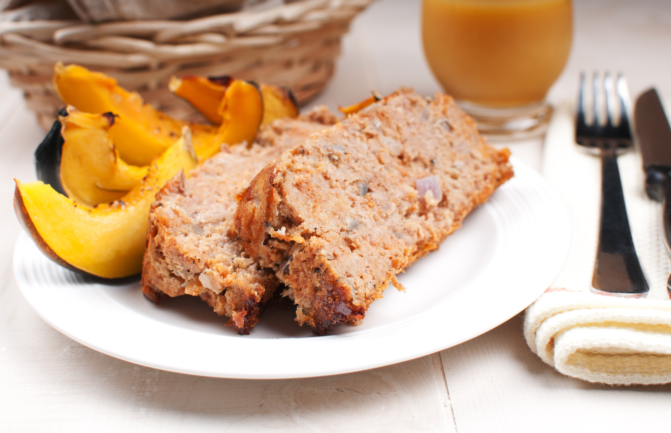 Healthy turkey meatloaf accompanied by a side of acorn squash.