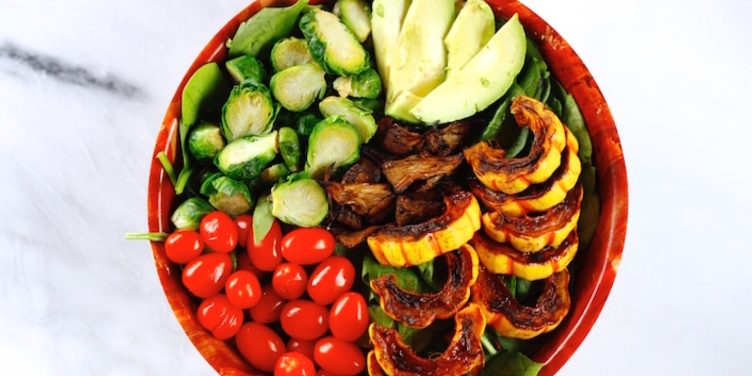 A bowl of squash salad with jackfruit bacon
