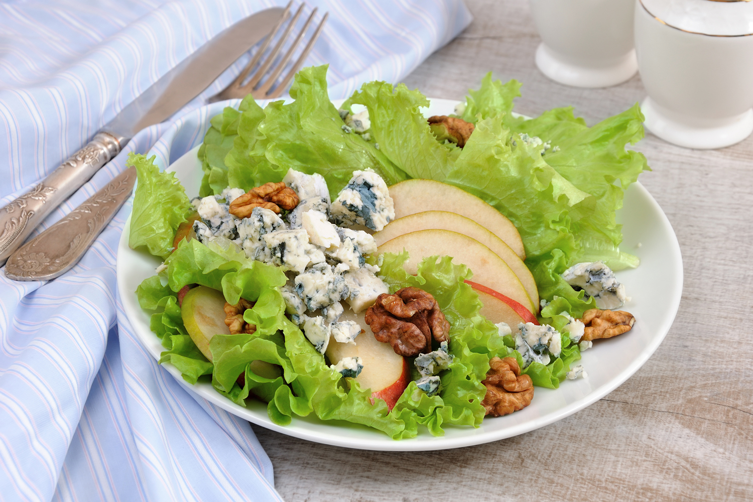 a green salad with pears, gorgonzola, and nuts
