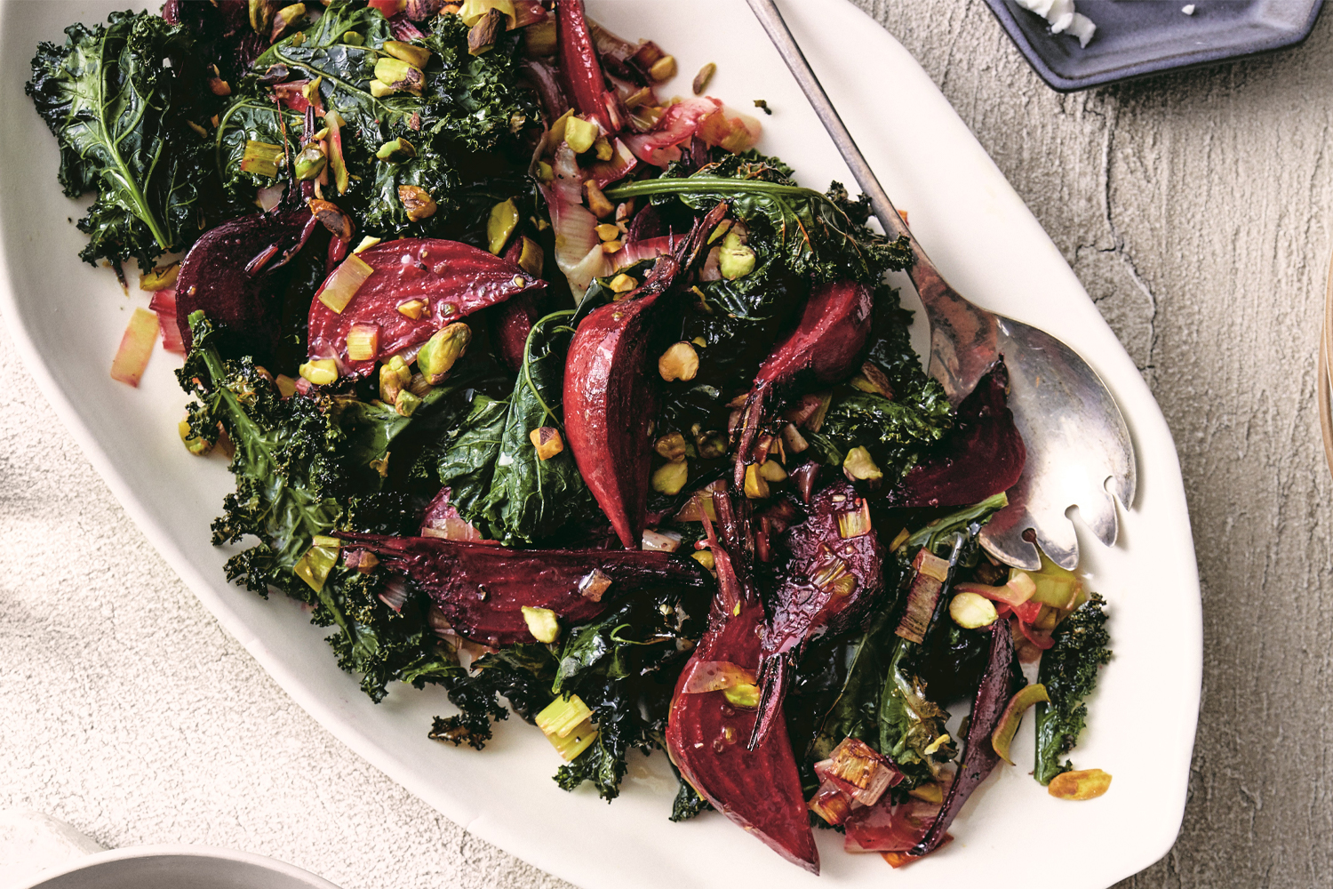 a plate of roasted vegetables with dressing