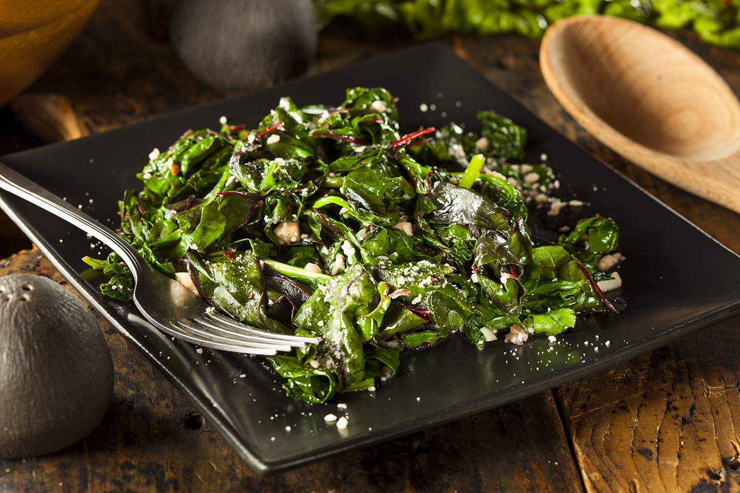 A plate of prepared leafy greens in garlic.