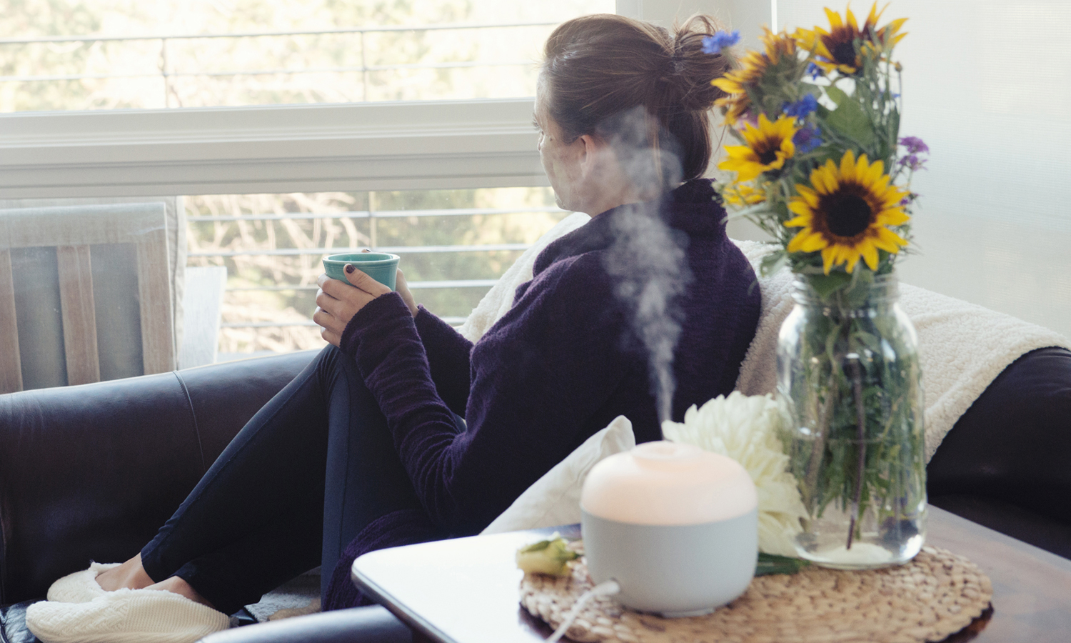 a woman using a diffuser