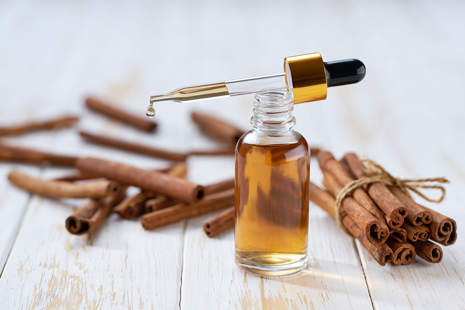cinnamon bark and a bottle of oil