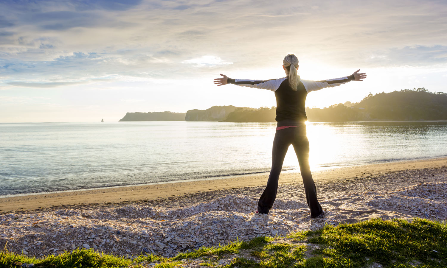 energized woman on the beach in the morning