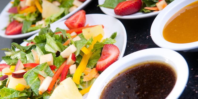assorted fruit and vegetable salads with oil and dressing