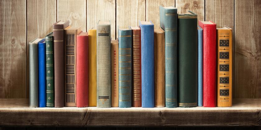 a shelf of reference books and cookbooks