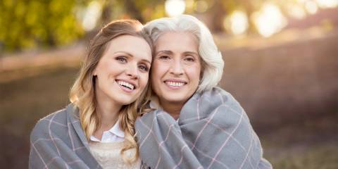 A young woman embraced by her older self