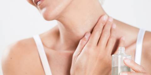 a woman applying oil to her sore, stiff neck