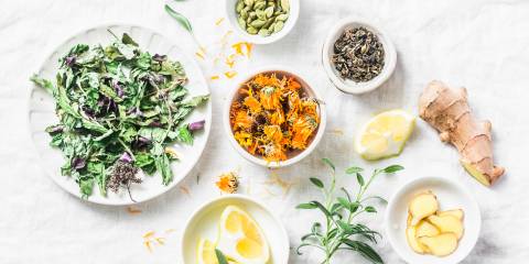 cleansing herbs, greens, and lemon for a detoxifying tea