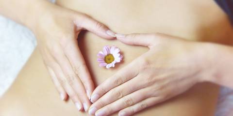 a young woman with a flower on her tummy