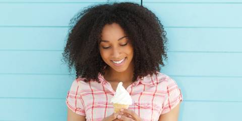 Woman smiling holding an ice cream cone.