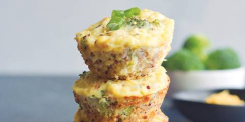 Cheesy Broccoli Quinoa Eggs Muffins stacked like a tower.