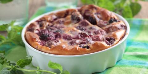 Blackberry clafoutis baked in white ramekin
