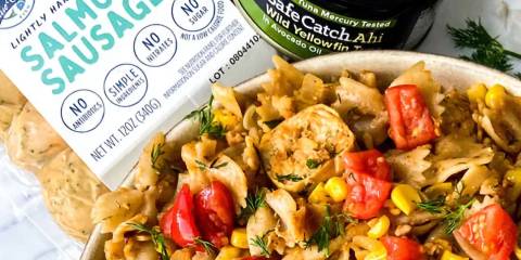 a bowl of pasta with fish and cajun spices