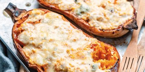 Twice baked butternut squash fresh out of the oven on a baking sheet.