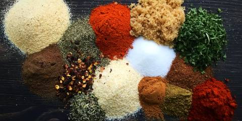 piles of herbs and spices used to make Jamaican jerk seasoning