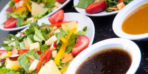 assorted fruit and vegetable salads with oil and dressing