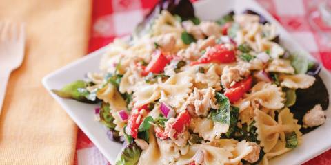 a plate of pasta with tuna and vegetables
