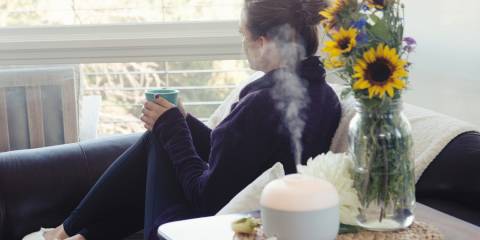 a woman using a diffuser