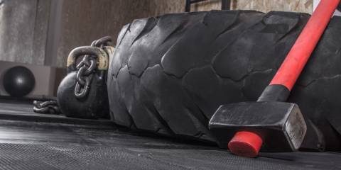 Different crossfit equipment used for crossfit training in a gym.