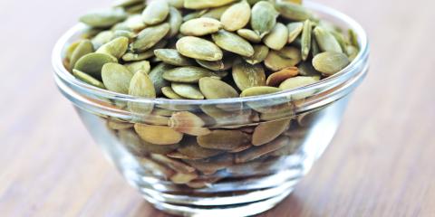 Pumpkin seeds in a glass bowl. 