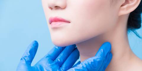 a woman having her thyroid glands checked