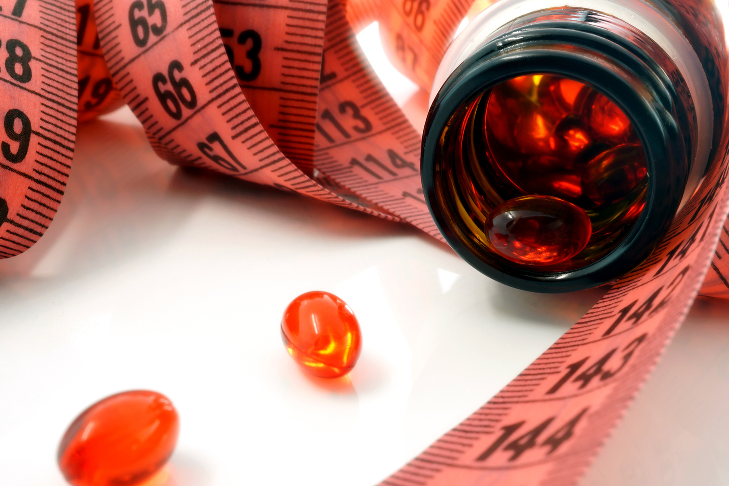 a measuring tape and a bottle of supplements
