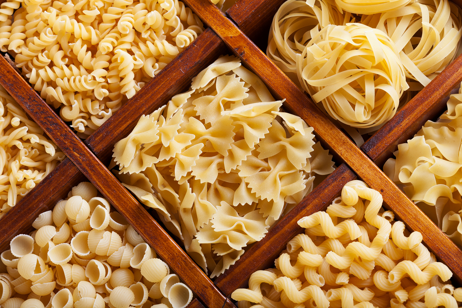 compartments filled with different shapes of pasta